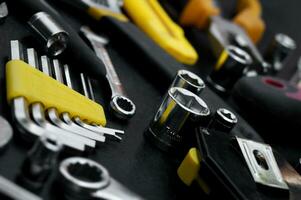 Many different tools for repair work on a black background. photo