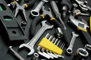 Many different tools for repair work on a black background. photo