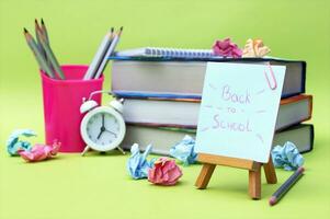 A small easel with a sticker with the inscription Back to School on the background of the educational installation. photo