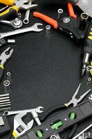 Many different tools for repair work on a black background with copy space for text. photo