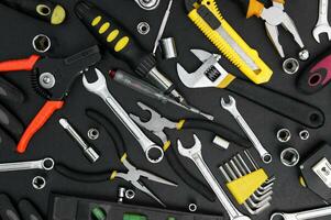 Many different tools for repair work on a black background. photo