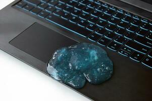 Blue soft gel cleaning dust on keyboard. photo