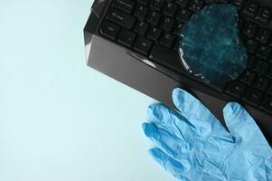 Blue soft gel cleaning dust on keyboard. photo