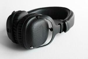 Portable black headphones on white background. photo