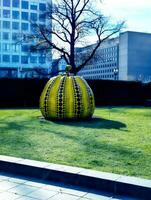 Washington DC, US - 12.16.2023 Close up of iconic yellow pumpkin by artist Yayoi Kusama in the Hirshhorn Museum and Sculpture Garden photo