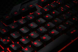 Backlit gaming keyboard close up. photo