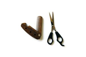 Male wooden comb and scissors for a haircut isolated on a white background. photo