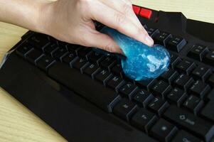 Blue soft gel cleaning dust on keyboard. photo