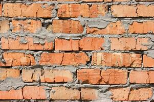 Old brick wall, old texture of red stone blocks closeup. photo