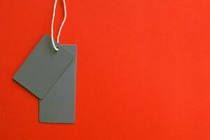 Two empty gray tags on a orange background. photo