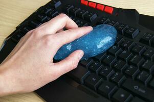 Blue soft gel cleaning dust on keyboard. photo