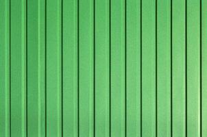 Green background of metal wall siding, cladding. photo