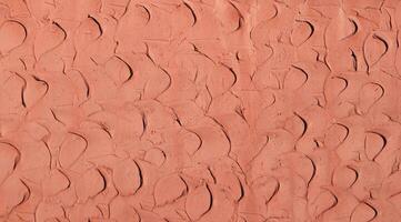 Red coral clay plaster walls, for use as a background and texture. photo