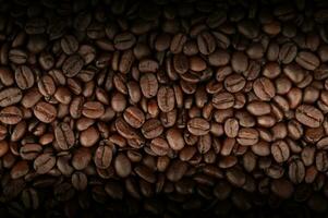 Mixture of different kinds of fresh roasted brown coffee beans in dark tones photo