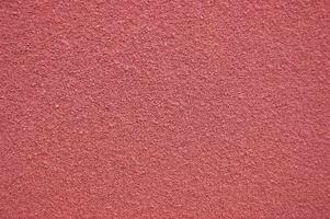 Red horizontal wall covered with plaster texture photo