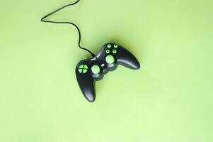 Joystick gaming controller isolated on green background. photo