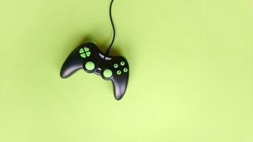 Joystick gaming controller isolated on green background. photo