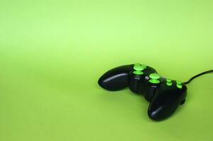 Joystick gaming controller isolated on green background. photo