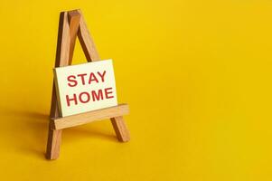 Yellow sticker with the words STAY HOME. photo