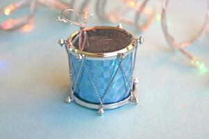 Christmas decoration for the Christmas tree in the form of drums on a blue background. photo