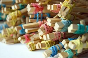 Many student's Chinese sticks with multi-colored rubber bands. photo