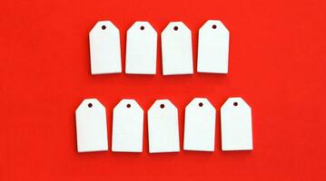 Nine wooden tags with space for text on a red background. photo