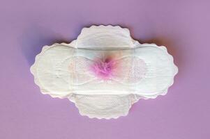 Menstrual pads with a fluff on a lilac background. photo