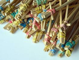 Many student's Chinese sticks with multi-colored rubber bands. photo
