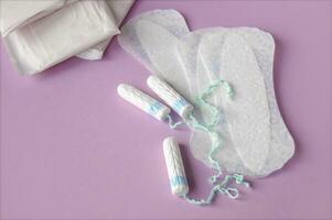 Menstrual pads and tampons on red background. photo