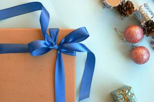 Christmas gift craft box on a blue background with decoration. photo