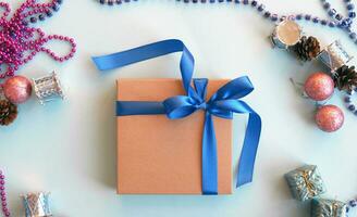 Christmas gift craft box on a blue background with decoration. photo