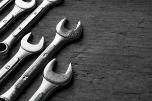 Wrenches of different sizes isolated on wood background photo