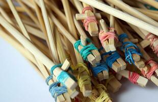 Many student's Chinese sticks with multi-colored rubber bands. photo