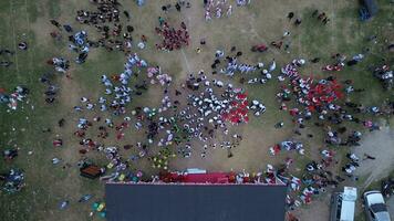 Aerial view of Indonesian flag lowering ceremony witnessed by villagers. Indonesia Independence Day photo