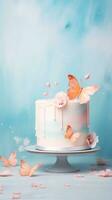 AI generated Elegant white cake with pink floral decorations and peach butterflies, set against a soft blue backdrop. Ideal for birthday or wedding celebrations. Vertical format. photo