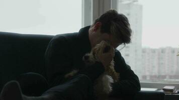 Companion's Embrace. Tender Moment Between Person and Pet Against City Backdrop video