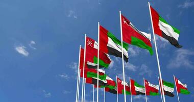 Omán y unido árabe emiratos, uae banderas ondulación juntos en el cielo, sin costura lazo en viento, espacio en izquierda lado para diseño o información, 3d representación video