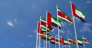 Suriname and United Arab Emirates, UAE Flags Waving Together in the Sky, Seamless Loop in Wind, Space on Left Side for Design or Information, 3D Rendering video