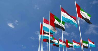 Luxembourg and United Arab Emirates, UAE Flags Waving Together in the Sky, Seamless Loop in Wind, Space on Left Side for Design or Information, 3D Rendering video