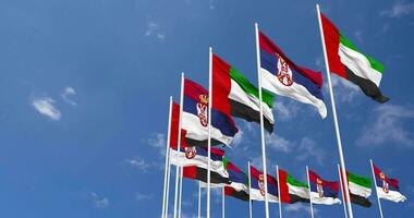 Serbia and United Arab Emirates, UAE Flags Waving Together in the Sky, Seamless Loop in Wind, Space on Left Side for Design or Information, 3D Rendering video