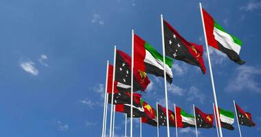 Papua New Guinea and United Arab Emirates, UAE Flags Waving Together in the Sky, Seamless Loop in Wind, Space on Left Side for Design or Information, 3D Rendering video