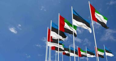 Estonia and United Arab Emirates, UAE Flags Waving Together in the Sky, Seamless Loop in Wind, Space on Left Side for Design or Information, 3D Rendering video