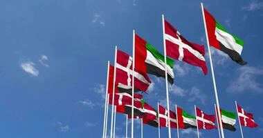 Denmark and United Arab Emirates, UAE Flags Waving Together in the Sky, Seamless Loop in Wind, Space on Left Side for Design or Information, 3D Rendering video