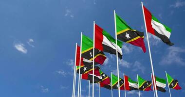 Saint Kitts and Nevis and United Arab Emirates, UAE Flags Waving Together in the Sky, Seamless Loop in Wind, Space on Left Side for Design or Information, 3D Rendering video