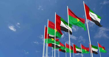 Burkina Faso and United Arab Emirates, UAE Flags Waving Together in the Sky, Seamless Loop in Wind, Space on Left Side for Design or Information, 3D Rendering video