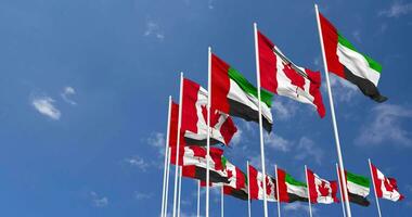 Canadá y unido árabe emiratos, uae banderas ondulación juntos en el cielo, sin costura lazo en viento, espacio en izquierda lado para diseño o información, 3d representación video