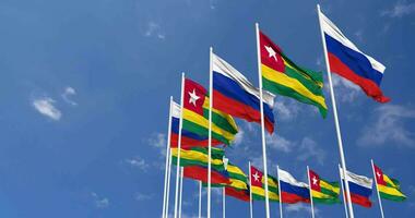 Togo and Russia Flags Waving Together in the Sky, Seamless Loop in Wind, Space on Left Side for Design or Information, 3D Rendering video