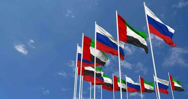 United Arab Emirates and Russia Flags Waving Together in the Sky, Seamless Loop in Wind, Space on Left Side for Design or Information, 3D Rendering video