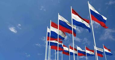 Paraguay and Russia Flags Waving Together in the Sky, Seamless Loop in Wind, Space on Left Side for Design or Information, 3D Rendering video