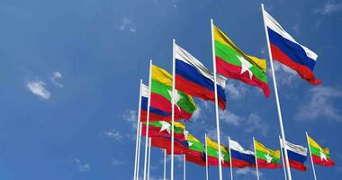 Myanmar, Burma and Russia Flags Waving Together in the Sky, Seamless Loop in Wind, Space on Left Side for Design or Information, 3D Rendering video